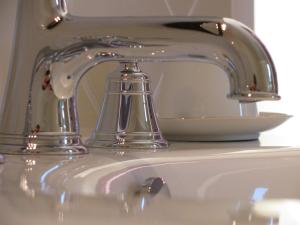 a silver faucet sitting on top of a sink at Chambres d'hôtes -B&B- La Bonneterie in Montaigut-le-Blanc