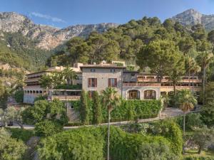 a house on a hill with trees and mountains at Es Moli in Deia