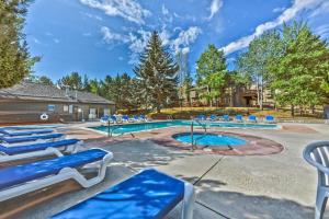 a swimming pool with blue chairs around it at 37C Hidden Creek Mountain Getaway! condo in Park City