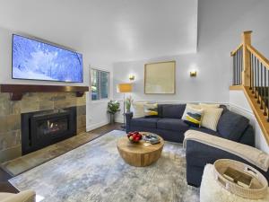 a living room with a blue couch and a fireplace at 37C Hidden Creek Mountain Getaway! condo in Park City