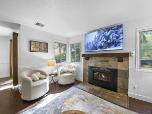 a living room with a fireplace and a flat screen tv at 37C Hidden Creek Mountain Getaway! condo in Park City