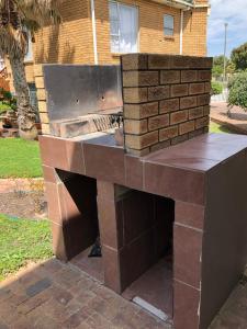 a brick fireplace in front of a house at Shearwater 106 in Sedgefield