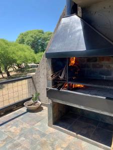 a stone oven with a fire inside of it at Apart Club San Pedro in San Pedro