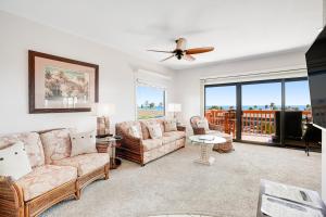 a living room with couches and a ceiling fan at Makanui at Poipu Resort 222 in Koloa