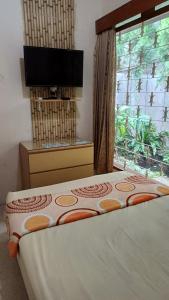 Postel nebo postele na pokoji v ubytování GIO Guesthouse Bogor