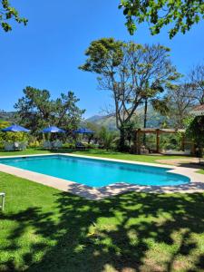 a swimming pool in the yard of a house at La Belle Provence in Itaipava