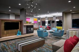 a lobby with a living room with furniture and a tv at Residence Inn by Marriott Lynchburg in Lynchburg