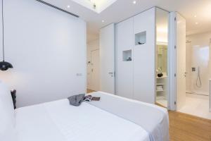 a white room with a bed and a shower at Amazing Vista Piazza Venezia in Rome +28 photos