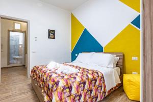 um quarto com uma cama com uma parede colorida em Casa di Angelo Vibrant Apartment em Perugia