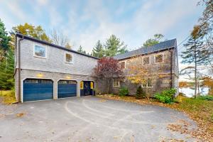 a large brick house with a garage at Maine Waterfront Luxury Retreat in Meadowbrook