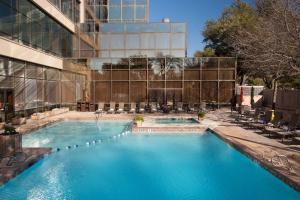 a swimming pool in front of a building at Renaissance Dallas Addison in Addison
