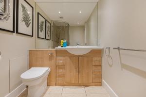 a bathroom with a sink and a toilet at Stylish Studio in Kensington in London