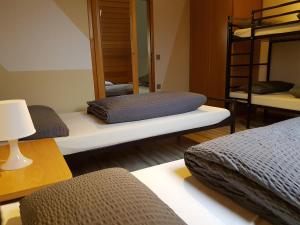 a room with three bunk beds and a mirror at Ferienhaus Bauer in Zirndorf