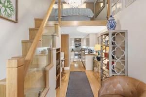 a staircase leading up to a kitchen in a house at Stylish Kensington Apartments in London