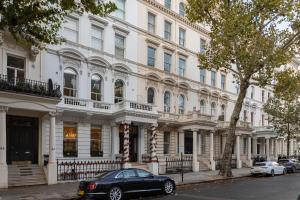 a black car parked in front of a large building at Stylish Kensington Apartments in London