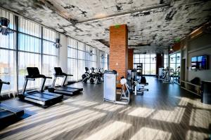 a gym with a lot of exercise equipment and windows at Zen Beach House Luxury 1-Bedroom Intracoastal Views in Hollywood