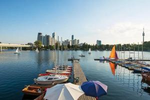 a bunch of boats are docked in a harbor at Rooftop cozy apartment near innerstadt with AC in Vienna