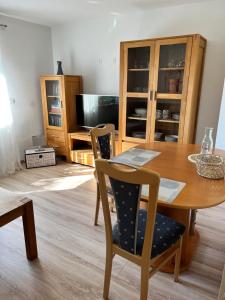 a dining room with a wooden table and chairs at Ferienwohnung LINA in Bitburg