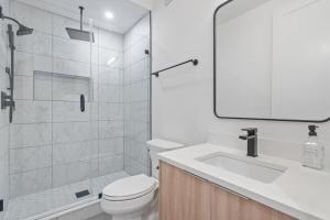 a bathroom with a toilet and a sink and a shower at Capitol View2 Townhouse Condo in Washington, D.C.