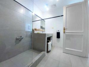 a bathroom with a shower and a glass door at BREEZE VIEW house by the sea in Corralejo