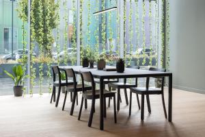 una mesa de comedor negra y sillas con plantas en Zedwell Greenwich en Londres