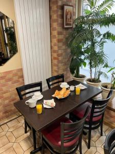a black table with a bowl of food on it at H&ocirc;tel Jarry Confort in Paris
