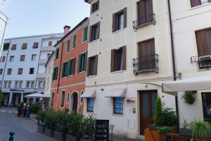 a group of buildings on the side of a street at Lombardi House in Treviso