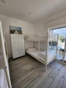 a room with two bunk beds and a window at BLife Faro Beach Hostel in Faro