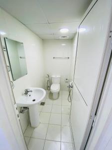 a bathroom with a toilet and a sink at SKY 9 Hostel ,UNION METRO in Dubai