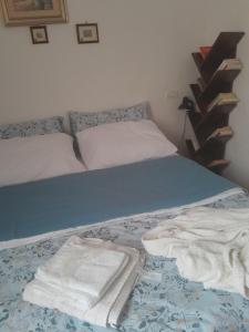 a bed with two towels on it in a bedroom at Sardinia Experience in Villamassargia