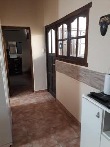 a room with a kitchen with a door and a window at KAKAN cómodo apartamento 1 dormitorio in Cafayate +8 photos