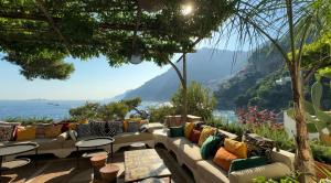 a patio with couches and a view of the ocean at Villa Treville in Positano