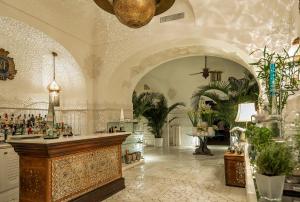 a lobby with a bar in a room with plants at Villa Treville in Positano