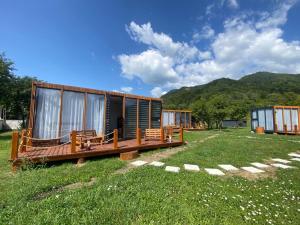 a cabin in the middle of a field of grass at Valea Regilor Happy Camp in Blidireasa