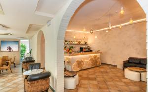 a lobby with a bar with chairs and a table at Hotel Euromar in Marina di Massa