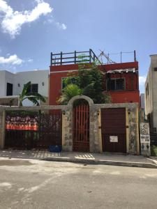 a building with a gate in front of a street at Mar y Luna in Mérida