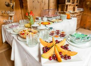 a long white table with food on it at Garni Tschutscherhof in Laion