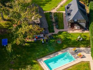 een uitzicht op een achtertuin met een zwembad bij Maisons Pommes in Ablon