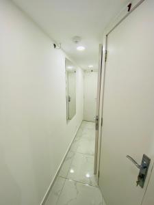 a hallway with a door and a tile floor at SKY 9 Hostel ,UNION METRO in Dubai