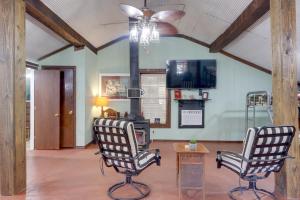 a living room with two chairs and a ceiling fan at Bunkhouse-Style Studio in Elkins Near ATV Trails! in Elkins