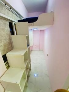 a room with white shelves and a ceiling at SKY 9 Hostel ,UNION METRO in Dubai
