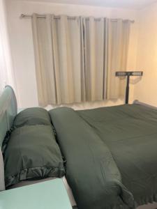 a bed with green pillows on it in a bedroom at 369 apartment 9 in Birmingham