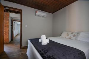 Un dormitorio con una cama con dos toallas encima. en 12 Hóspedes - Piscina Àgua Salgada e Área Gourmet, en Foz do Iguaçu 47 fotos más