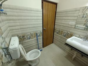 a bathroom with a toilet and a sink at Snow Drop Guest House in Gangtok