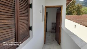 a wooden door in a house with a hallway at +A apartamentos in São Sebastião