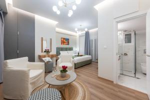a living room with a couch and a bed and a table at Acropolis Divine Apartments in Athens