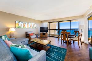 a living room with a couch and a table at Ocean Front Spectacular Condo in Honolulu