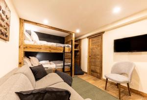 a living room with a couch and a bunk bed at Ashmour Alpine in Les Gets