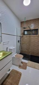 a bathroom with a sink and a toilet and a shower at SUITES-HOME, CIDADELA in Praia