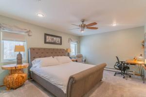 a bedroom with a bed and a ceiling fan at Charming Family Haven On the Loop in Fairbanks